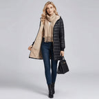 Women's long puffer coat, three quarter view with the hood up