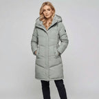 Women's padded parka in pastel green, worn outdoors