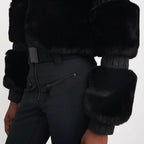 Women's Aspen ski suit in black worn on the snow