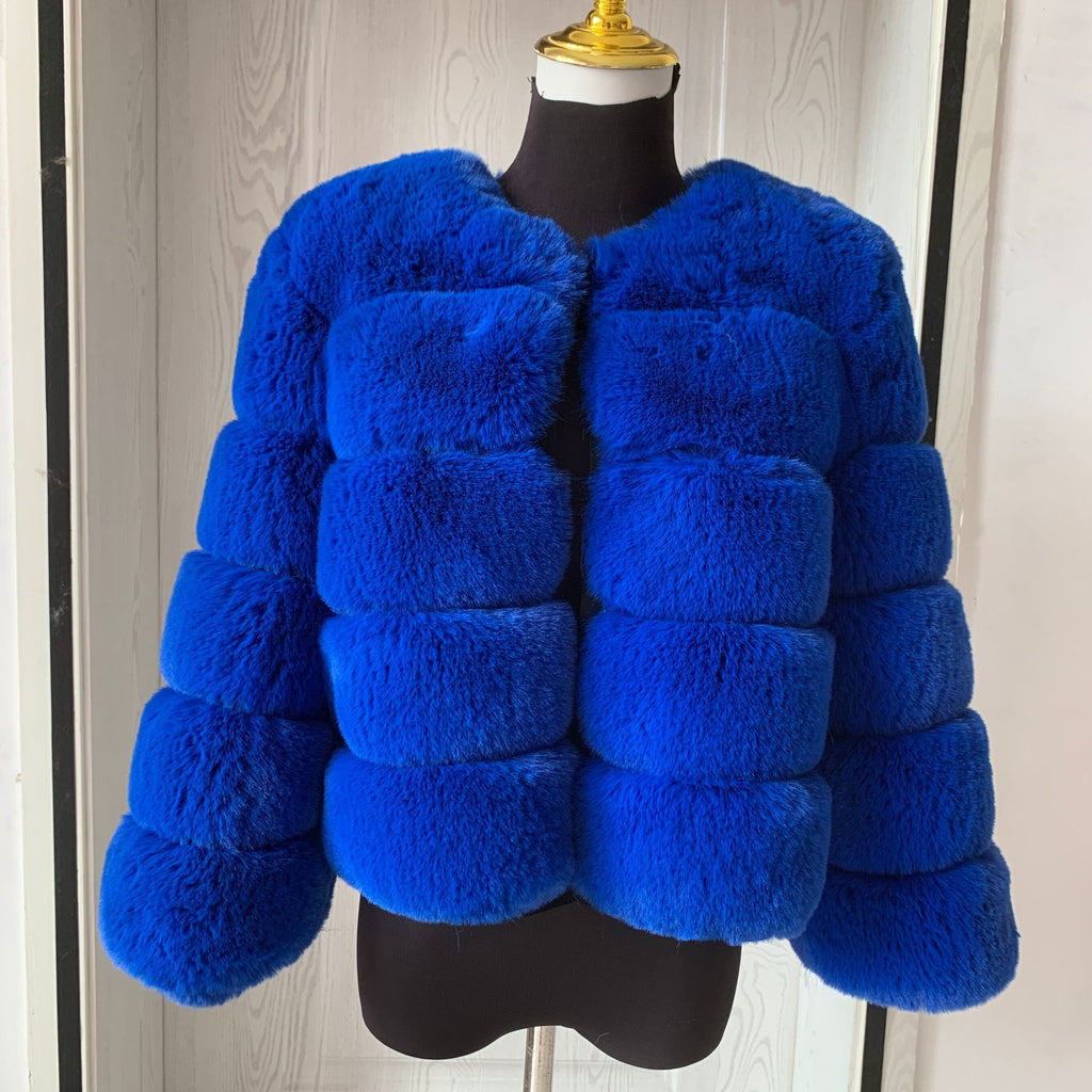 Women's faux fur coat worn open over a winter outfit